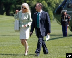 FILE - White House senior adviser Kellyanne Conway, left, and White House Chief of Staff Reince Priebus walk across the South Lawn of the White House in Washington, May 17, 2017.