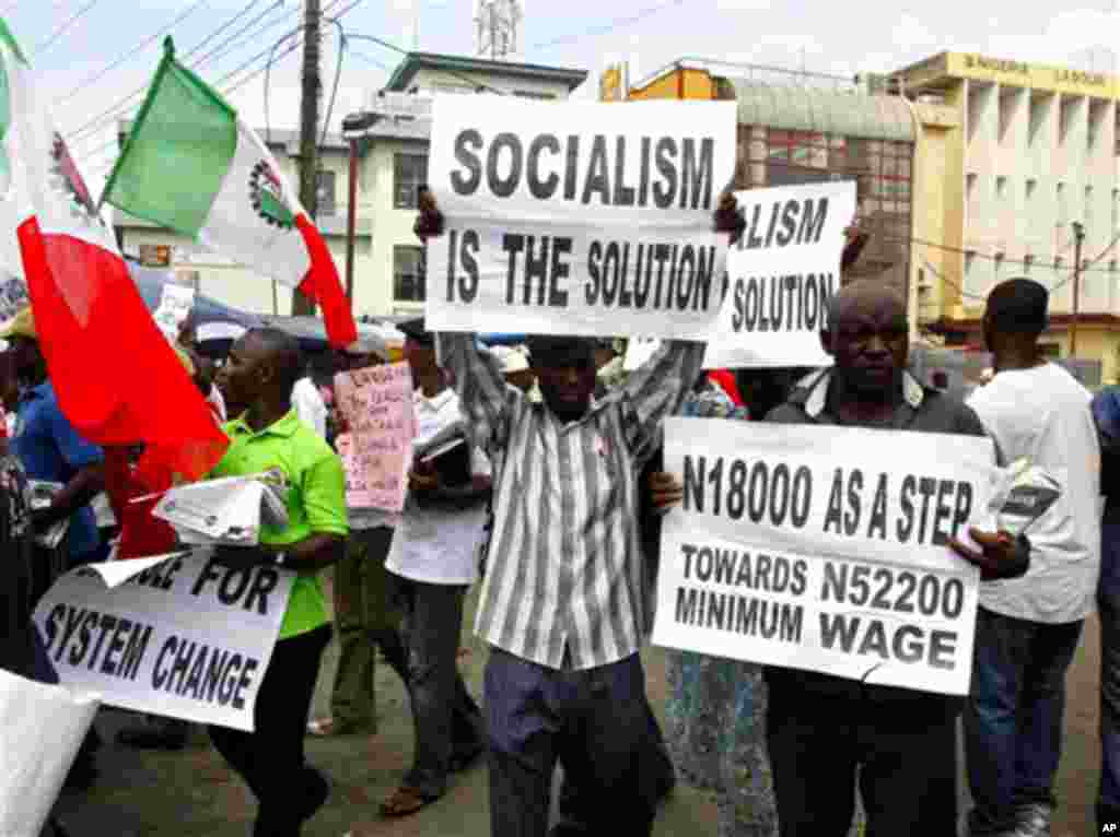 Trade union members display placards during a protest, in Lagos, Nigeria, Wednesday, Nov. 10, 2010. Trade unions protesting Nigeria's minimum wage have called a warning strike across the oil-rich nation. Wednesday's strike by the Nigerian Labor Congress a