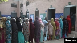 Women wait in line to vote for local government elections in Lahore, Pakistan, Oct. 31, 2015.