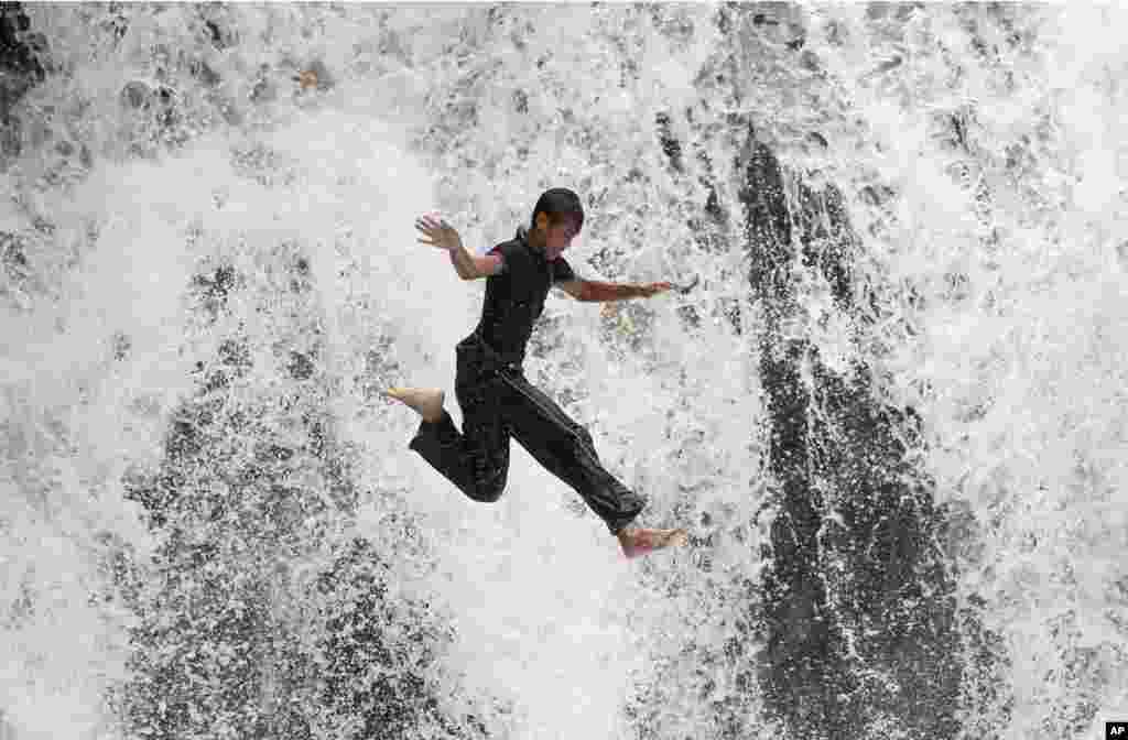 A man stretches at the Yuyuantan Park in Beijing, China.