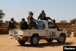 FILE - U.N. peacekeepers patrol in Aguelhok, Mali, Jan. 24, 2014.