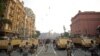 FILE - Egyptian military helicopters fly overhead as army soldiers stand guard at an entrance to Tahrir Square, in Cairo, Egypt, Oct. 6, 2013. The United States on July 26, 2018, released $195 million in military aid to Egypt that had been withheld because of concerns about the country's human rights record.