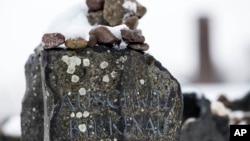 FILE - Stones lie on a Auschwitz-Birkenau memorial stone during the international Holocaust remembrance day in the former Nazi concentration camp Buchenwald near Weimar, Germany, Jan. 27, 2015. A German court says a 95-year-old man will go on trial next month on 3,681 counts of accessory to murder for allegedly serving in the Nazis' Auschwitz death camp.