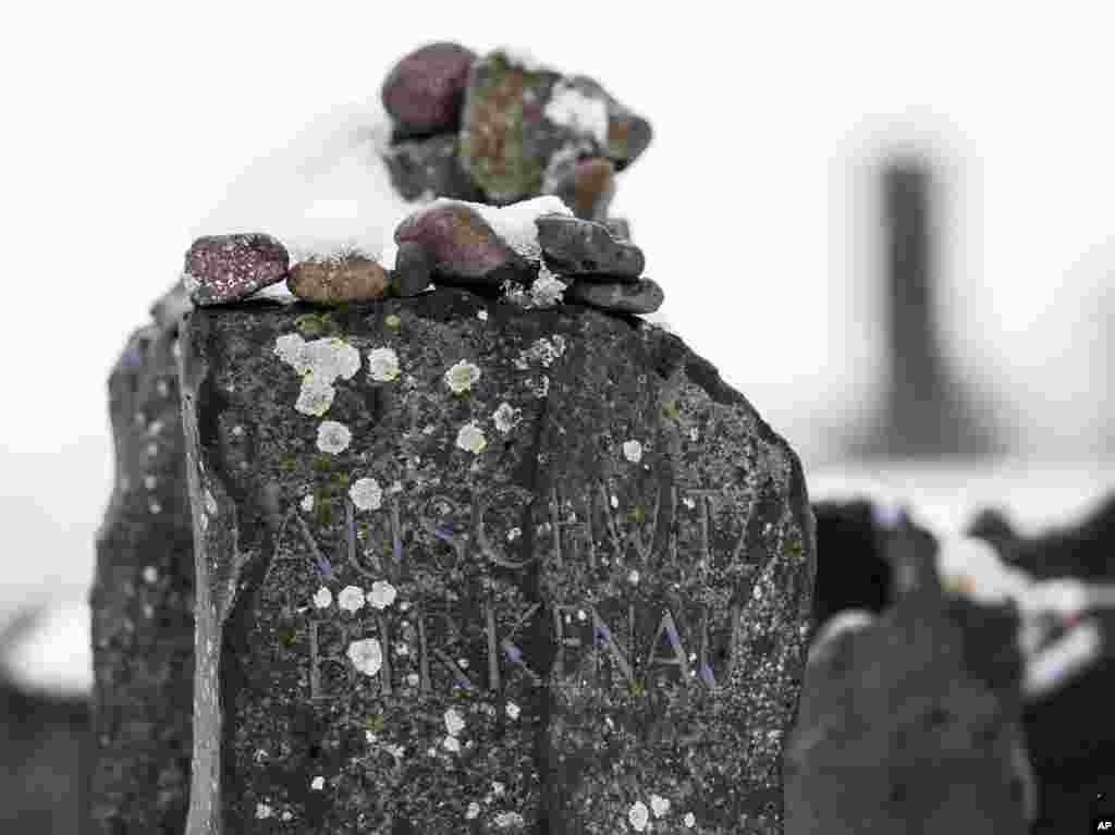 Stones lie on a Auschwitz-Birkenau memorial stone during the international Holocaust remembrance day in the former Nazi concentration camp Buchenwald near Weimar, Germany, Jan. 27, 2015. 