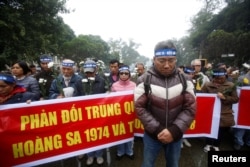People take part in an anti-China protest to mark the 43rd anniversary of the China's occupation of the Paracel Islands in the South China Sea in Hanoi, Vietnam, Jan. 19, 2017.