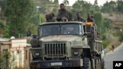 FILE - Ethiopian government soldiers ride in the back of a truck in the Tigray region of northern Ethiopia, May 11, 2021. 