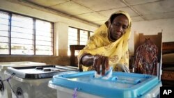 An elderly Tanzanian woman casts her vote in the presidential election at a polling station in Dar es Salaam, Tanzania, Oct. 25, 2015.