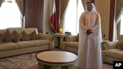Emir of Qatar, Sheik Tamim bin Hamad Al Thani, waits for the arrival of U.S. Secretary of Defense Chuck Hagel, in Doha, Qatar. Dec. 10, 2013.