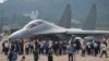 Visitors look at the Chinese military's J-16D electronic warfare airplane during 13th China International Aviation and Aerospace Exhibition, also known as Airshow China 2021, on Wednesday, Sept. 29, 2021, in Zhuhai in southern China's Guangdong province. 