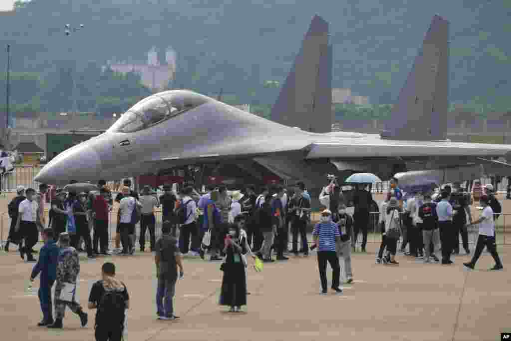 Visitors look at the Chinese military&#39;s J-16D electronic warfare airplane during 13th China International Aviation and Aerospace Exhibition, also known as Airshow China 2021 in Zhuhai in southern province of Guangdong.