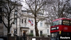 FILE - A person walks in front of the Russian Embassy in London, Britain, Jan. 23, 2022. 