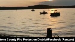 Rescue personnel work after an amphibious duck boat capsized and sank at Table Rock Lake near Branson, Missouri, July 19, 2018, in this still image obtained from a video on social media. (SOUTHERN STONE COUNTY FIRE PROTECTION DISTRICT/Facebook/via REUTERS)