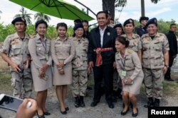 Thailand's Prime Minister Prayuth Chan-ocha poses for photo with local government officers at a farmer school in Suphan Buri province, Thailand, Sept. 18, 2017.