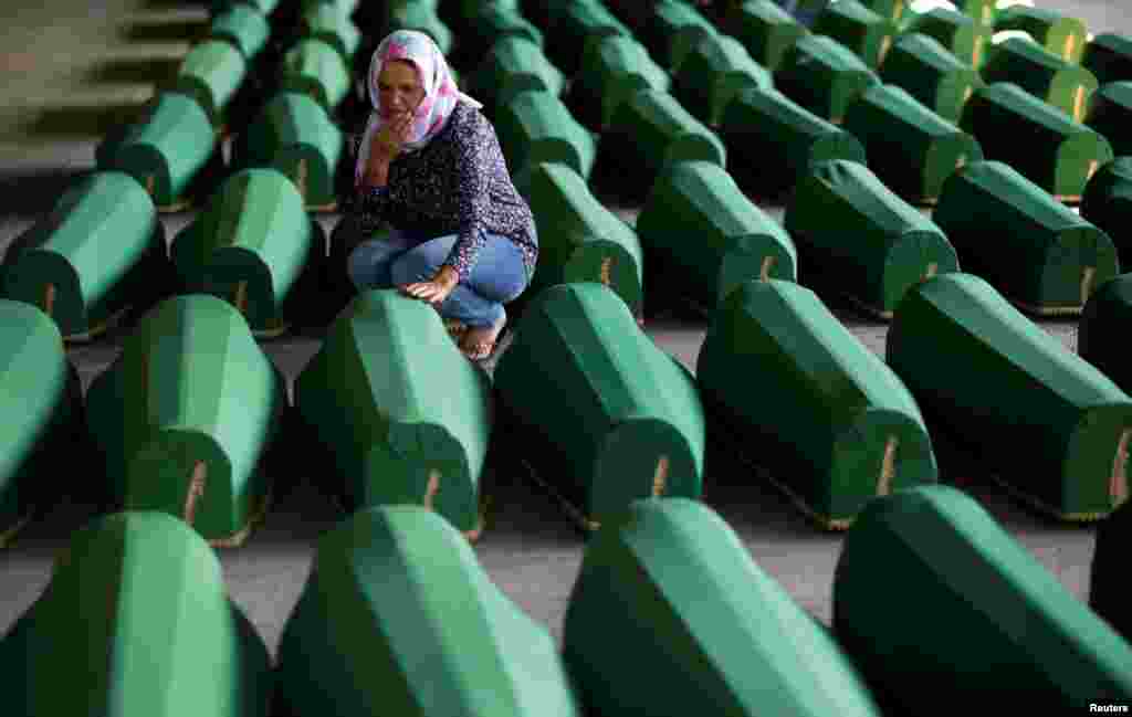 Muslim women cry near coffins of their relatives, who are newly identified victims of the 1995 Srebrenica massacre, which are lined up for a joint burial in Potocari near Srebrenica, Bosnia and Herzegovina.