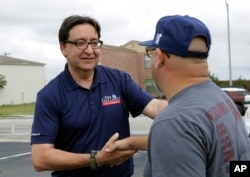 U.S. House of Representative democratic candidate Pete Gallego, left, makes a stop at a polling site, Nov. 8, 2016, in San Antonio, Texas.