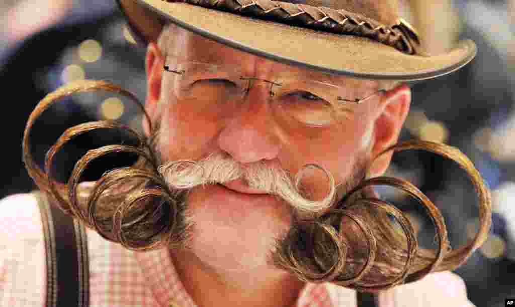 Participant Dieter Besuch shows his beard with which he competes in the Whiskers Freestyle category of the International German Beard Championships at Congress Centrum in Pforzheim, Germany.