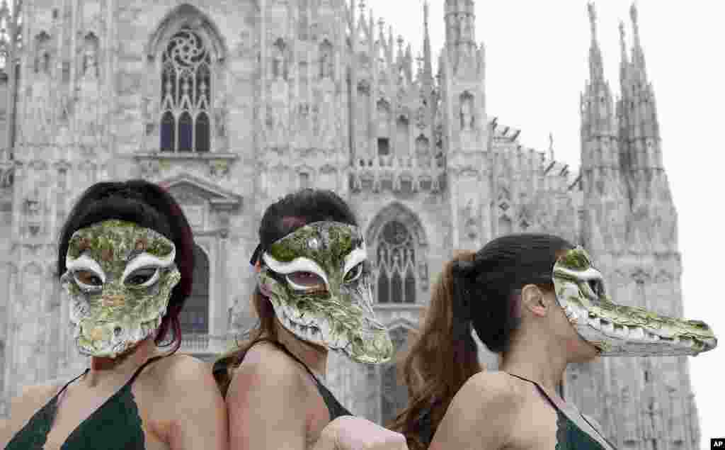 Para aktivis hak-hak binatang, PETA (People for the Ethical Treatment of Animals) memakai topeng buaya pada aksi protes menentang penggunaan kulit buaya pada pameran busana di Milan, Italia.