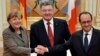 Ukrainian President Petro Poroshenko, center, French President Francois Hollande, right, and German Chancellor Angela Merkel shake hands during their meeting in Kyiv, Ukraine, Thursday, Feb. 5, 2015.