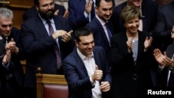 Greek Prime Minister Alexis Tsipras gives a thumbs-up after winning a confidence vote in Athens, Greece, Jan. 16, 2019. 