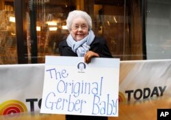 FILE - Ann Turner Cook, whose baby face launched the iconic Gerber logo, arrives at NBC’s Today Show to announce the winner of the 2012 Gerber Generation Photo Search, Nov. 6, 2012, in New York City.