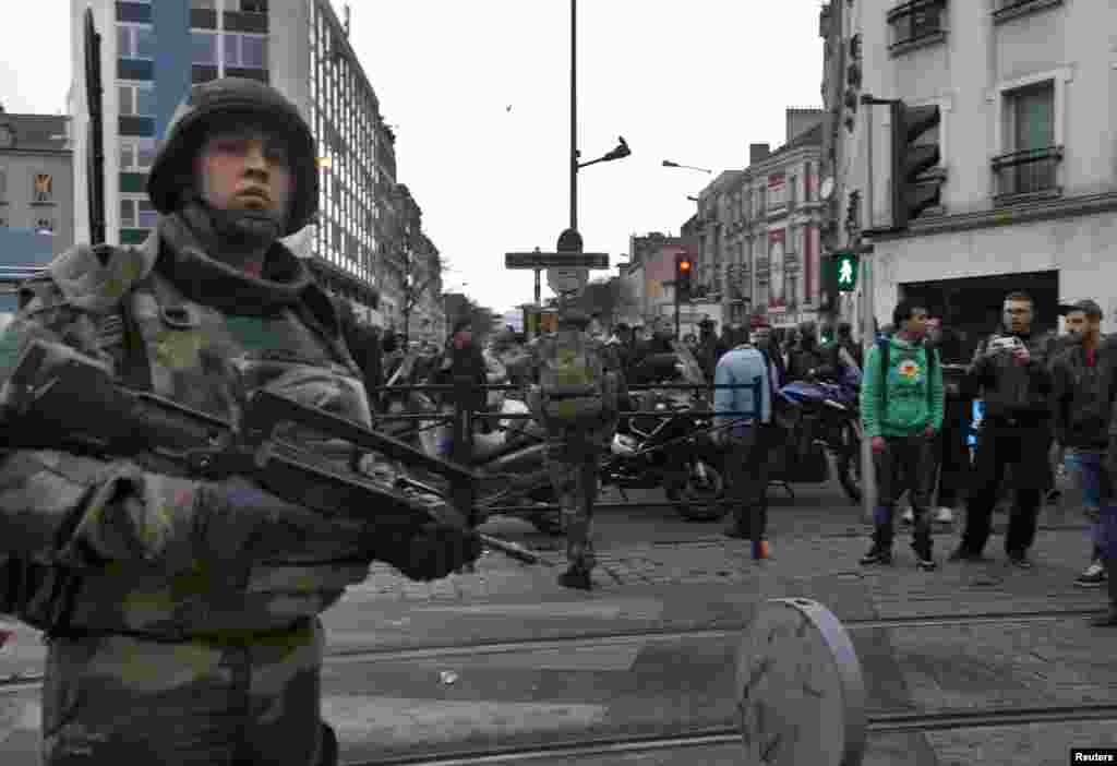 French soldiers secure the area as shots are exchanged in Saint-Denis, France, near Paris, Nov. 18, 2015 during an operation to catch fugitives from Friday night's deadly attacks in the French capital. 