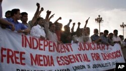 FILE - Pakistani journalists and members of civil society chant slogans during a rally to mark the World Press Freedom Day, May 3, 2008, in Islamabad, Pakistan.
