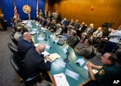 Florida Gov. Rick Scott, far center, holds a statewide roundtable on school safety at the Florida Capitol in Tallahassee, Feb 20, 2018.