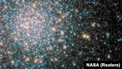 A globular star cluster called Messier 5 (M5) containing 100,000 stars or more and packed into a region around 165 light-years in diameter is seen in an undated image taken by NASA's Hubble Space telescope and released April 25, 2014. Messier 5 lies some 25,000 light-years away and its stars are estimated to be nearly 13 billion years old, according to NASA. 