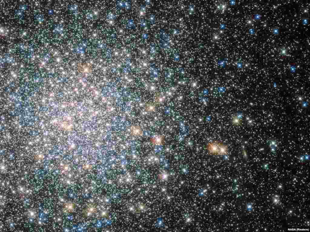 A globular star cluster called Messier 5 (M5) containing 100,000 stars or more and packed into a region around 165 light-years in diameter is seen in an undated image taken by NASA&#39;s Hubble Space telescope and released April 25, 2014.