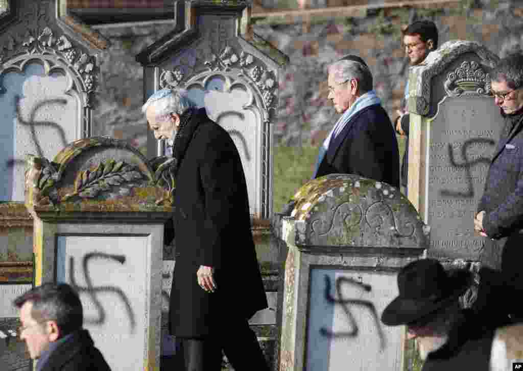 Members of the Jewish community walk amid vandalized tombs in the Jewish cemetery of Westhoffen, west of the city of Strasbourg, eastern France.