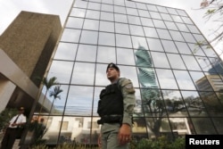 A police officer stands guard outside the Mossack Fonseca law firm office in Panama City, April 12, 2016.