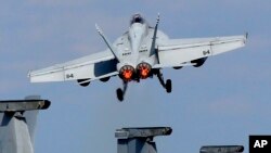 A U.S. Navy F/A-18 Super Hornet takes off from the flight deck of the USS George Washington during "Keen Sword" U.S.-Japan joint military exercise over the Pacific Ocean, Dec. 10, 2010.