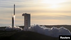 FILE - An Atlas 5 rocket carrying a satellite is launched from Vandenberg Air Force Base in California.