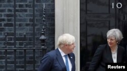 FILE - Britain's Prime Minister Theresa May (R) is seen alongside Foreign Secretary Boris Johnson, at 10 Downing street in London, May 11, 2017. 