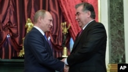 FILE - Russian President Vladimir Putin shakes hands with his Tajikistan's counterpart Emomali Rakhmon (R) at the Kremlin, Moscow.