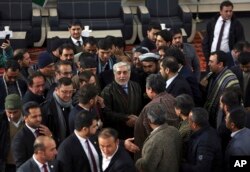 Afghanistan Chief Executive Abdullah Abdullah, center, shakes hands with his supporters after arriving to register as a candidate for the presidential election, in Kabul, Jan. 20, 2019.