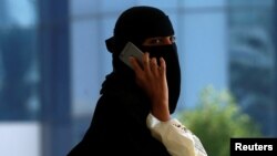 FILE - A Saudi woman speaks on the phone in Riyadh, Saudi Arabia, Oct. 2, 2017.