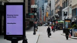 Peatones caminan por la zona comercial casi vacía de Downtown Crossing (centro de Boston) después de que el gobernador de Massachusetts, Charlie Baker, extendiera la orden de permanencia en el hogar y de cerrar negocios no esenciales hasta el 18 de mayo debido a la COVID-19.