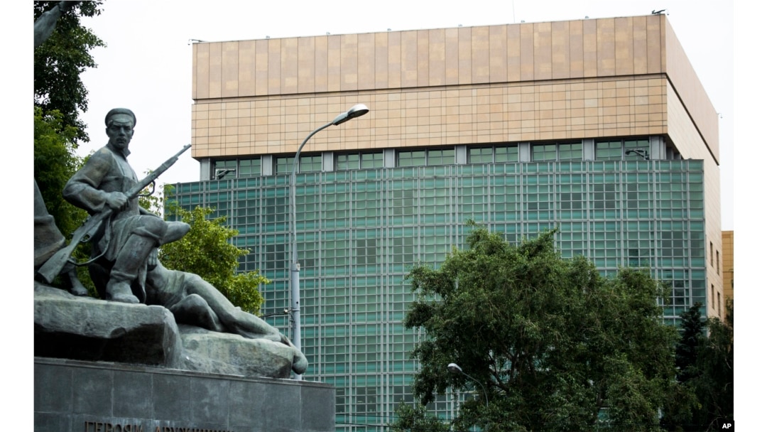 FILE - The U.S. Embassy in Moscow, with a monument to Russian revolutionary workers in the foreground, July 28, 2017.