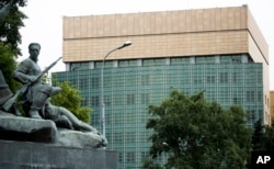 FILE - The U.S. Embassy in Moscow, with a monument to Russian revolutionary workers in the foreground, July 28, 2017.