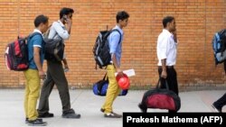 Nepalese migrant workers arrive at the Tribhuvan International Airport in Kathmandu on September 27, 2013. If the the GCC approves a Kuwaiti proposal, migrant workers seeking employment in Gulf countries will undergo mandatory gender tests.