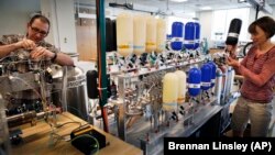 Laboratory scientists work with air samples from around the world for climate change research, at the University of Colorado, in Boulder, Colorado.