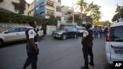 National police stand outside a radio station, center, after the arrest of Guy Philippe in Petion-Ville, Haiti, Jan. 5, 2017.
