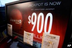 A sign displays the estimated Powerball lottery jackpot amount at a gas station in Dallas, Texas, Jan. 9, 2016.