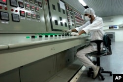 FILE - An Iranian technician works at the Uranium Conversion Facility just outside the city of Isfahan, Iran.