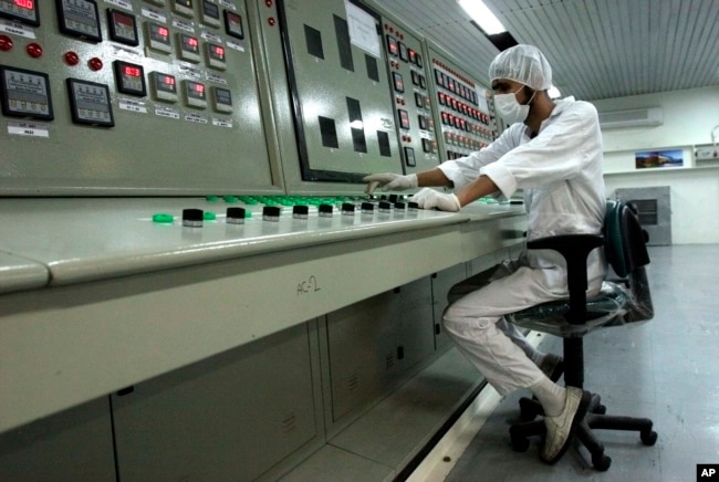 FILE - An Iranian technician works at the Uranium Conversion Facility just outside the city of Isfahan, Iran.