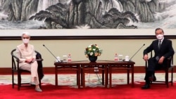 In this photo provided by the U.S. Department of State, U.S. Deputy Secretary of State Wendy Sherman, left, and Chinese Foreign Minister Wang Yi sit together in Tianjin, China, Monday, July 26, 2021. (U.S. Department of State via AP)