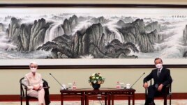 In this photo provided by the U.S. Department of State, U.S. Deputy Secretary of State Wendy Sherman, left, and Chinese Foreign Minister Wang Yi sit together in Tianjin, China, Monday, July 26, 2021. (U.S. Department of State via AP)