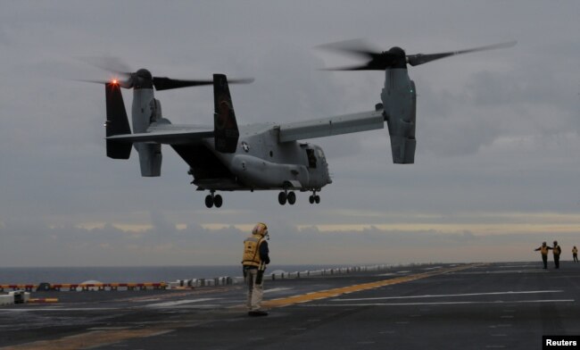 FILE - A U.S. Marines MV-22 Osprey Aircraft lands on the deck of the USS Bonhomme Richard amphibious assault ship off the coast of Sydney, Australia, June 29, 2017.