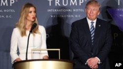 FILE - Republican presidential candidate Donald Trump listens as his daughter Ivanka Trump speaks during the grand opening of Trump International Hotel in Washington.